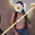 Woman with long dark hair in a pink crop top and jeans, face covered by a white flower sticker; orange promotional text about Mersin escort services.